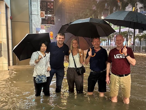AHDB staff stood in flooded street in Hong Kong.